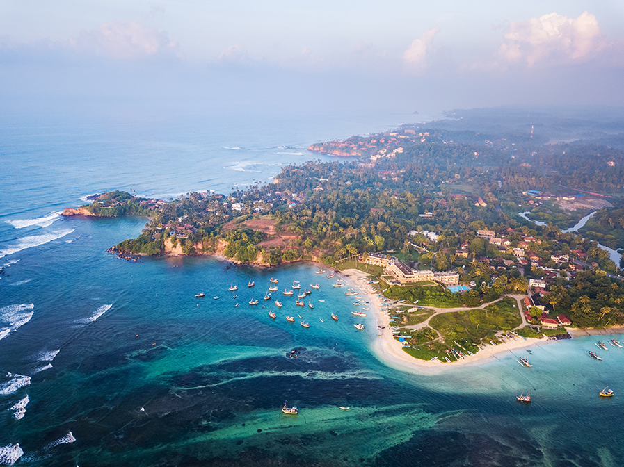 Aerial view of the Weligama cape with fishing village at sunrise. Sri Lanka